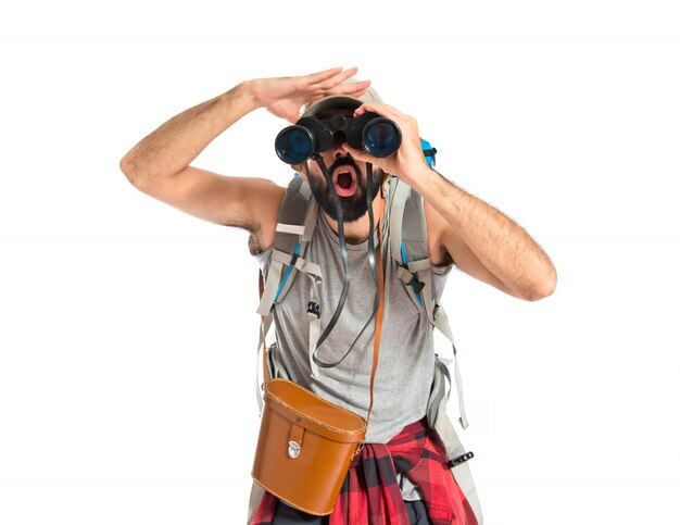 Backpacker with binoculars over isolated white background