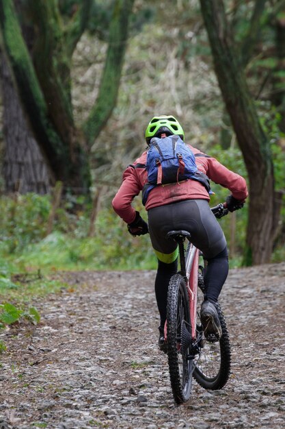 Backshot of a cross-country cyclist riding a bike