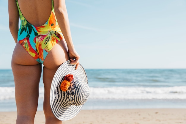 Free photo backview of woman at the beach