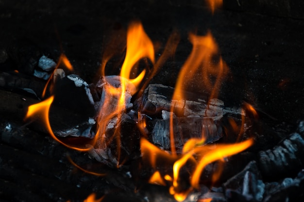 燃える残り火でいっぱいの裏庭の屋外暖炉