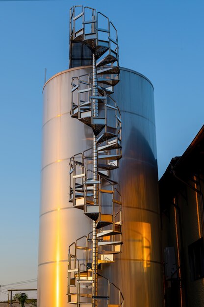 Backyard of winery at sunset with metal wine storage tanks