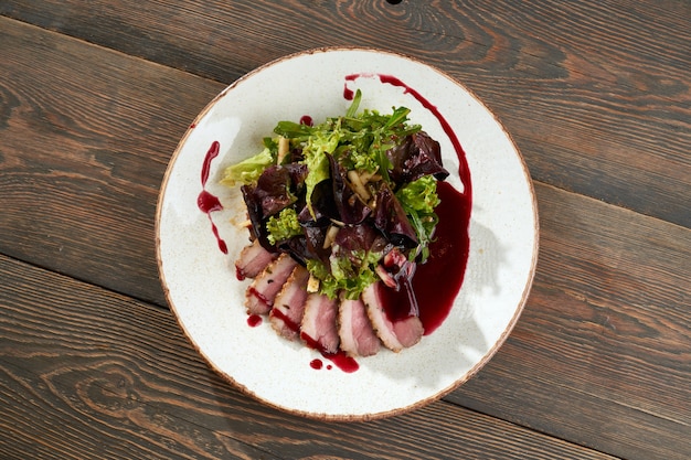 Bacon slices served with cranberry sauce and lettuce