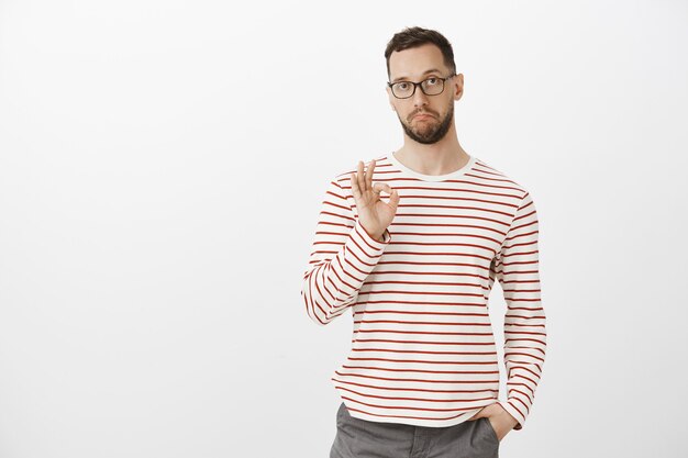 Not bad, like your idea, good job. Satisfied impressed attractive guy in glasses and striped clothes