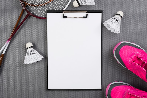 Free photo badminton equipment with clipboard composition