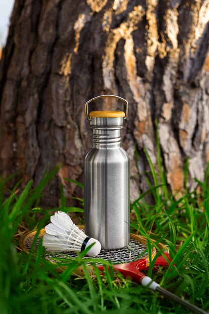 Badminton racket and flask outdoors