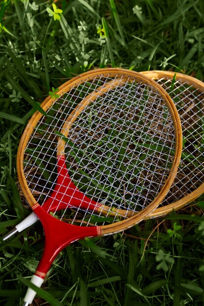 Badminton rackets on grass top view