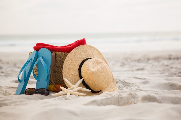 Bag and beach accessories kept on sand