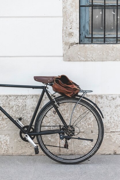 Bag on bicycle parked near the wall