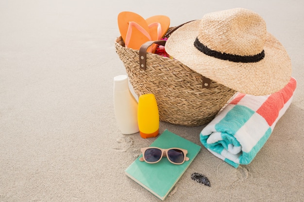 Bag with beach accessories on sand