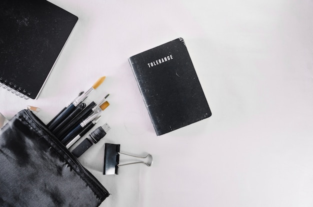 Bag with brushes near notebook