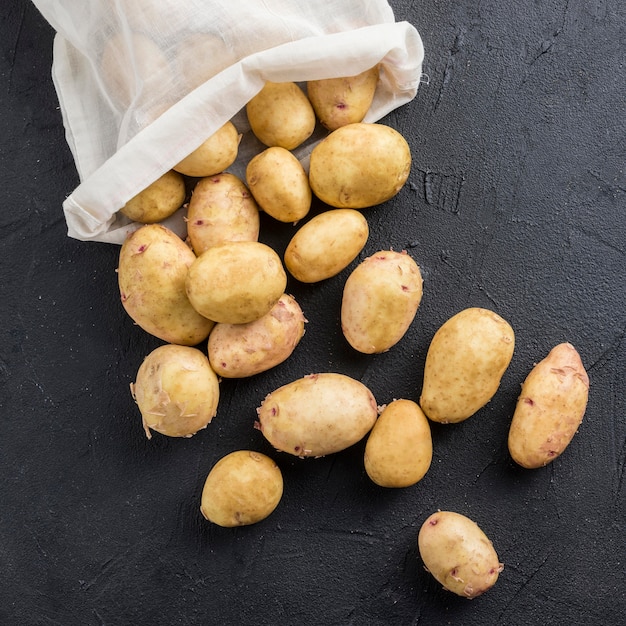 Bag with potatoes on table