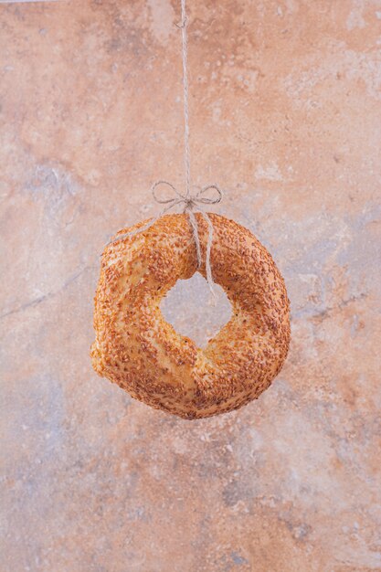 A bagel with sesame on marble surface