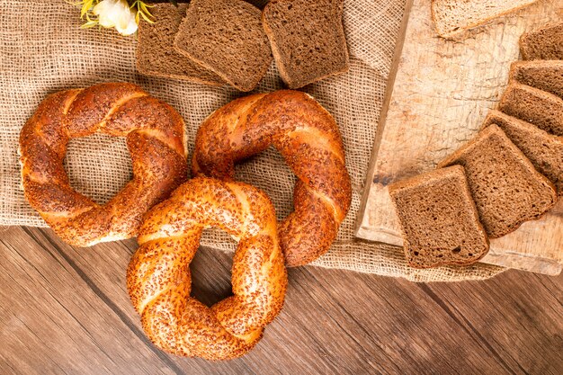 Bagels and slices of bread in basket and on tablecloth