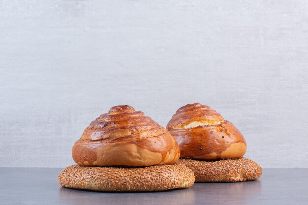 Bagels under sweet buns on marble background. High quality photo