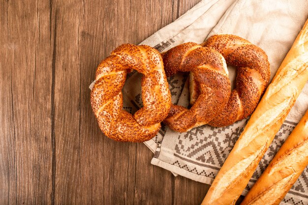 Bagels with french baguette on tablecloth