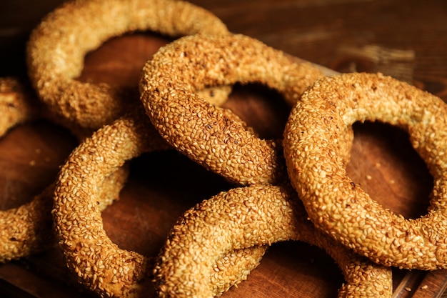 Bagels on the wooden board dough sesame side view