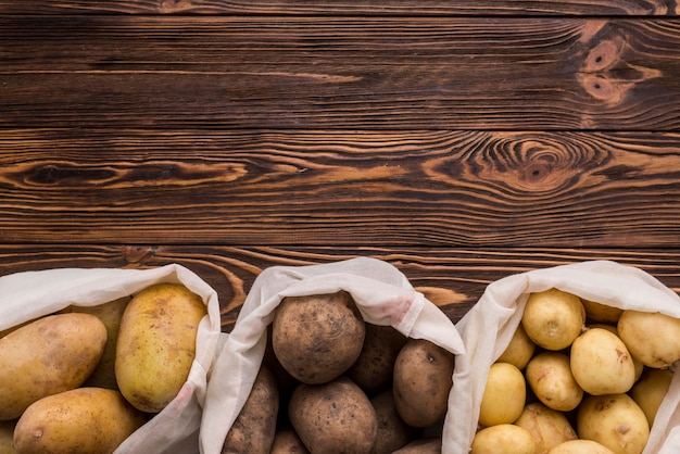 Free photo bags with potatoes on floor