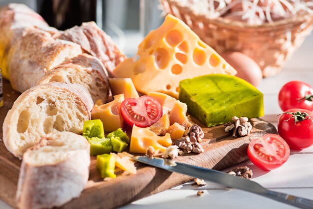 The baguette and cheese on wooden background