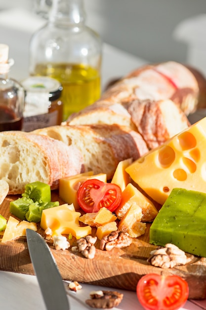 The baguette and cheese on wooden background