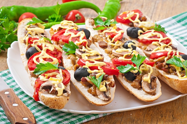 Baguette stuffed with veal and mushrooms with tomatoes and cheese