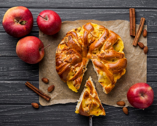 Baked apple pie and slice on cloth