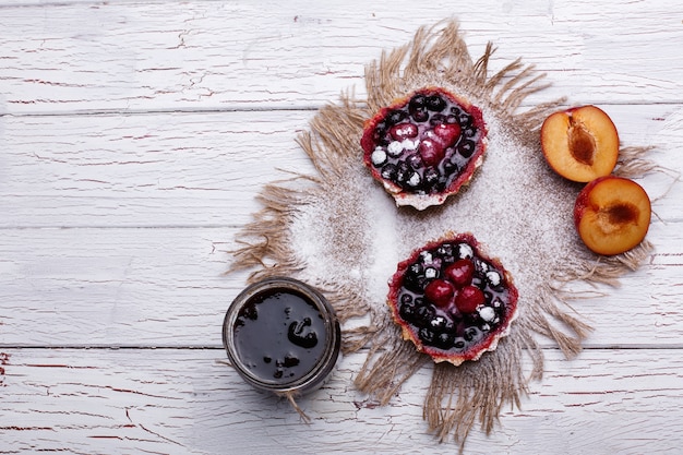 Baked baskets with berries, sweet cream and honey