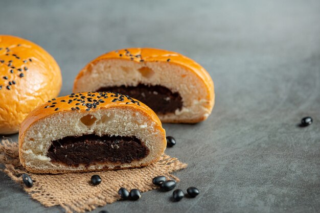 baked black bean paste buns put on dark floor