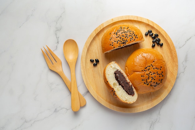 baked black bean paste buns put on wooden plate