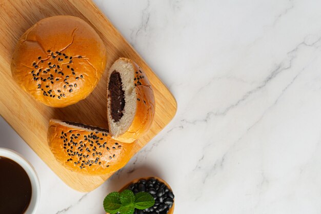 baked black bean paste buns on wooden cutting board