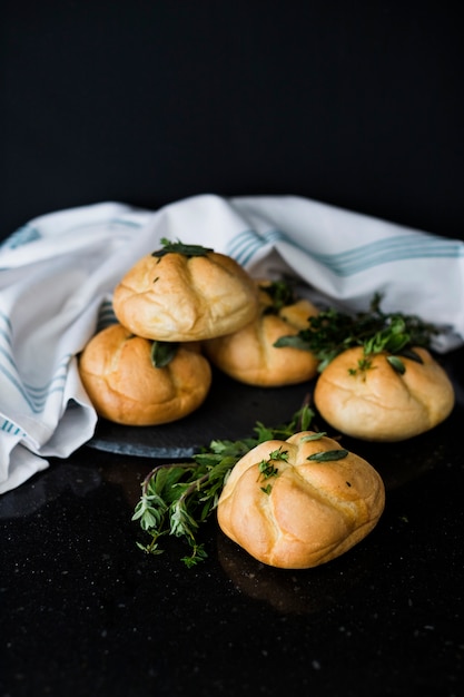 Free photo baked buns and thymes against black background