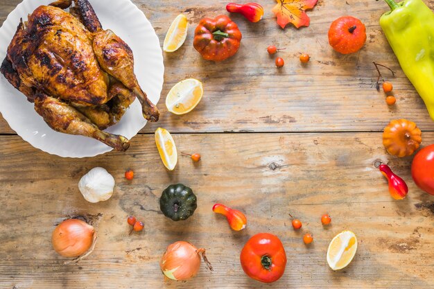 Baked chicken near vegetables