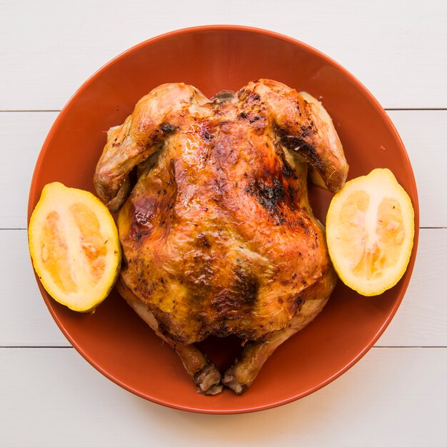 Baked chicken with lemon on plate