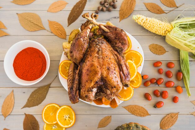 Baked chicken with oranges on plate