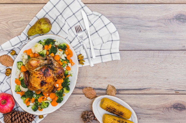 Baked chicken with vegetables on table 