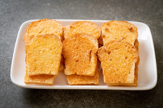 Premium Photo Baked Crispy Bread With Butter And Sugar On Plate Premium Photo Baked Crispy Bread With Butter And Sugar On Plate
