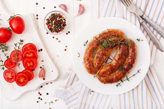 Baked homemade sausage on a white plate. Thanksgiving Day. Top view