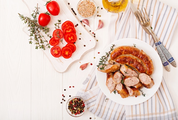 Baked homemade sausage on a white plate. Thanksgiving Day. Top view