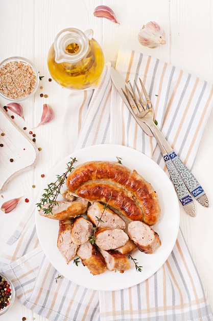 Free photo baked homemade sausage on a white plate. thanksgiving day. top view