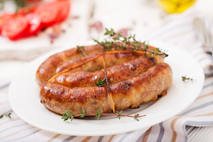 Free Photo baked homemade sausage on a white plate. thanksgiving day.