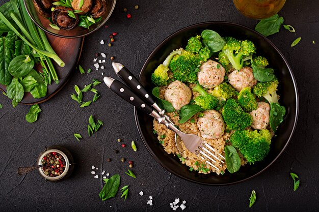 Baked meatballs of chicken fillet with garnish with quinoa and boiled broccoli. Proper nutrition. Sports nutrition. Dietary menu. Top view