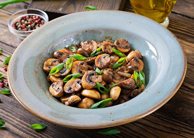 Baked mushrooms with soy sauce and herbs. Vegan food.