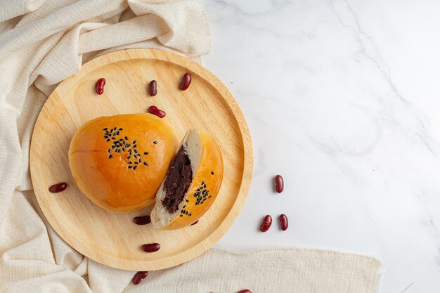 baked red bean paste buns on wooden plate