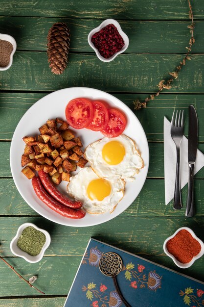 Baked sausage with eggs and potato