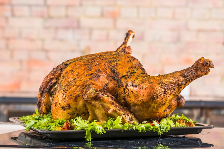Free Photo baked turkey with lettuce on pan 