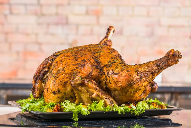 Baked turkey with lettuce on pan 