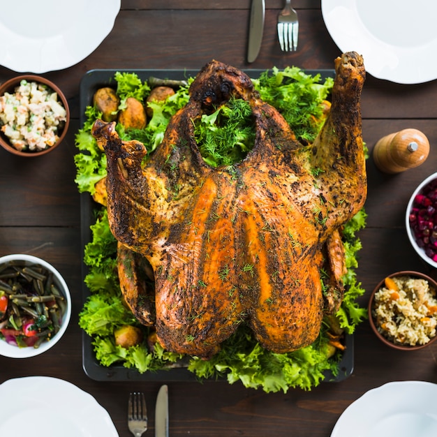 Baked turkey with salads on table