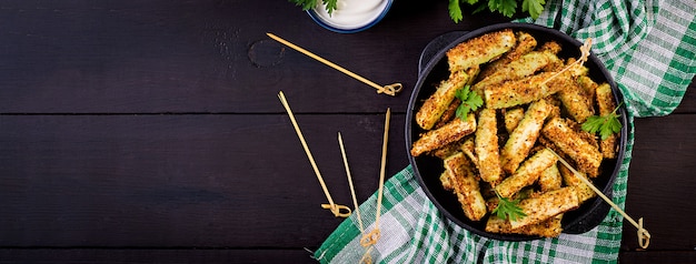 Baked zucchini sticks with cheese and bread crumbs