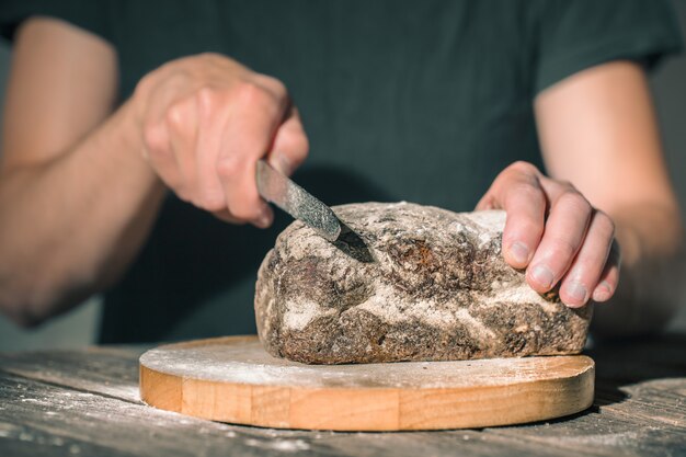 baker holding fresh bread in hands