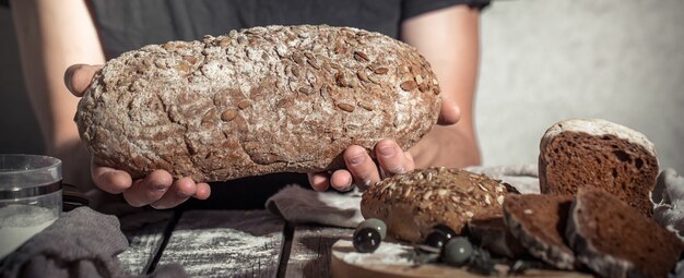 baker holding fresh bread in hands