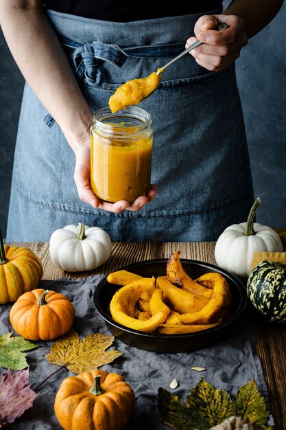 Baker holding a jar of pumpkin puree pie dessert ingredient closeup